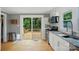 Modern kitchen features white cabinets, stainless steel appliances and a sliding glass door to a deck at 1209 Rainbow Dr, Kannapolis, NC 28081