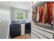 Well-lit laundry room with washer, dryer, and custom shelving at 1209 Rainbow Dr, Kannapolis, NC 28081