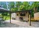 Cozy outdoor shed featuring a TV, table, speakers, and charming patio seating area at 1209 Rainbow Dr, Kannapolis, NC 28081