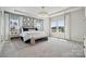 Serene main bedroom featuring stylish decor, tray ceiling, and ample natural light at 1217 Margo Mannor Dr, Fort Mill, SC 29708
