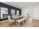 Modern dining room features panelled accent wall, neutral furnishings, and bright natural light throughout at 1217 Margo Mannor Dr, Fort Mill, SC 29708