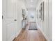 Inviting hallway with light wood floors and white walls, leading to a bright entryway at 1217 Margo Mannor Dr, Fort Mill, SC 29708