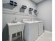 Functional laundry room with sink, white appliances, and shelving for storage at 1217 Margo Mannor Dr, Fort Mill, SC 29708