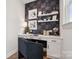 Cozy home office with decorative wallpaper, floating shelves, and a comfortable work space at 1217 Margo Mannor Dr, Fort Mill, SC 29708