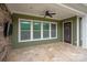 Covered patio boasts stone accents and a ceiling fan at 1244 Weir Ct, Fort Mill, SC 29708