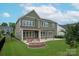 Green home backyard with patio and Adirondack seating around a firepit at 1244 Weir Ct, Fort Mill, SC 29708
