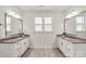 Well-lit bathroom with double vanity, white cabinets, and wood-look tile flooring at 1244 Weir Ct, Fort Mill, SC 29708
