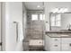 Modern bathroom featuring glass shower, neutral vanity, and two windows for natural light at 1244 Weir Ct, Fort Mill, SC 29708