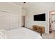 View of bedroom with closet, doorway to bath, TV, and view of comfy white bed at 1244 Weir Ct, Fort Mill, SC 29708
