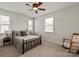 Cozy bedroom with a metal bed frame, carpet, and ample natural light from two windows at 1244 Weir Ct, Fort Mill, SC 29708