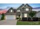 Beautiful two-story home with a well-kept lawn, stone accents, and attached garage at 1244 Weir Ct, Fort Mill, SC 29708