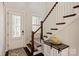 Inviting entry area with hardwood floors, decorative staircase, and front door with shutters at 1244 Weir Ct, Fort Mill, SC 29708