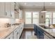 Modern kitchen with white cabinets, granite countertops, and stainless steel appliances at 1244 Weir Ct, Fort Mill, SC 29708