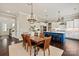 Open-concept kitchen and dining room with blue island, stainless appliances, and modern lighting at 1244 Weir Ct, Fort Mill, SC 29708