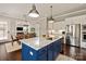 Beautiful kitchen with blue island, granite counters, stainless appliances, and decorative lighting at 1244 Weir Ct, Fort Mill, SC 29708