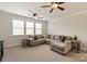 Spacious living room with L-shaped couch, neutral decor, and carpeted flooring at 1244 Weir Ct, Fort Mill, SC 29708