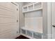 All-white mudroom with bench, cubbies, and coat hooks; functional and stylish storage space at 1244 Weir Ct, Fort Mill, SC 29708