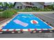 Colorful parking spot with scooter and beach-themed design, adding a playful touch at 1244 Weir Ct, Fort Mill, SC 29708