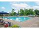Outdoor community pool with clear blue water, lounge chairs, and umbrellas for relaxation at 1244 Weir Ct, Fort Mill, SC 29708