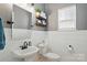 Half-bath features a stylish shiplap wall, modern sink, and decorative floating shelves at 147 Whitley Mills Rd, Fort Mill, SC 29708