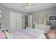 Bright bedroom featuring a ceiling fan, closet, and a cozy pastel-colored bed at 147 Whitley Mills Rd, Fort Mill, SC 29708