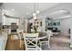 Open-concept kitchen and living area features stainless appliances, white cabinets and hardwood floors at 147 Whitley Mills Rd, Fort Mill, SC 29708