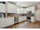 This kitchen boasts stainless steel appliances, white cabinets, granite counters and a stylish tile backsplash at 147 Whitley Mills Rd, Fort Mill, SC 29708