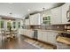 This open kitchen has white cabinets, stainless appliances, granite counters, and an adjacent breakfast nook at 147 Whitley Mills Rd, Fort Mill, SC 29708