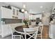 Open kitchen and nook showcases stainless appliances, white cabinets and stylish decorative lighting at 147 Whitley Mills Rd, Fort Mill, SC 29708