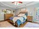 Well-lit primary bedroom featuring hardwood floors, decorative rugs, a trey ceiling, and neutral paint at 147 Whitley Mills Rd, Fort Mill, SC 29708
