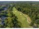 An aerial view shows the golf course community surrounded by dense trees at 1525 Valhalla Dr, Denver, NC 28037
