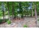 A serene backyard features a stone pathway, wooden bridge, and lush greenery at 1525 Valhalla Dr, Denver, NC 28037