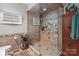 Bathroom with a glass-enclosed shower featuring a rainfall showerhead and built-in shelves at 1525 Valhalla Dr, Denver, NC 28037