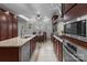 A kitchen and dining area featuring an island with a stainless steel sink, granite countertops, and stainless appliances at 1525 Valhalla Dr, Denver, NC 28037