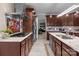 A kitchen featuring stainless steel appliances, a stained-glass window, granite countertops, and cherry wood cabinets at 1525 Valhalla Dr, Denver, NC 28037