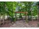 Secluded outdoor seating area featuring a charming pergola and stone pathway within a fenced yard at 1525 Valhalla Dr, Denver, NC 28037