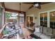 Relaxing screened-in porch with comfortable seating, ceiling fans, and neutral tones at 1525 Valhalla Dr, Denver, NC 28037