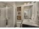 Modern bathroom featuring a glass-enclosed shower, a vanity with a sink, and decorative framed photos at 15344 Cimarron Hills Ln, Charlotte, NC 28278