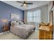 Cozy bedroom featuring a full-sized bed, carpet floors, a ceiling fan, and natural light at 15344 Cimarron Hills Ln, Charlotte, NC 28278