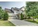 Charming two-story home with a well-manicured lawn and a spacious driveway leading to a two-car garage at 15344 Cimarron Hills Ln, Charlotte, NC 28278