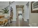 Hallway with hardwood floors leading to the living room and stairs with stylish decor at 15344 Cimarron Hills Ln, Charlotte, NC 28278