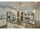Bright kitchen featuring a stainless steel sink and island with pendant lighting at 15344 Cimarron Hills Ln, Charlotte, NC 28278
