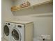 Functional laundry room with a folding counter, modern washer and dryer, and overhead shelving at 15344 Cimarron Hills Ln, Charlotte, NC 28278