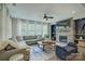 Inviting living room featuring a stone fireplace, comfortable seating, and large windows at 15344 Cimarron Hills Ln, Charlotte, NC 28278
