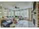 Bright living room with a stone fireplace, plush seating, and large windows at 15344 Cimarron Hills Ln, Charlotte, NC 28278