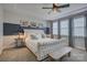 Stylish primary bedroom featuring tray ceilings and soft natural light from multiple windows at 15344 Cimarron Hills Ln, Charlotte, NC 28278