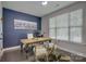 Stylish home office with a dark accent wall, a rustic desk, and ample natural light at 15344 Cimarron Hills Ln, Charlotte, NC 28278