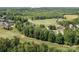 Aerial view showcasing homes on a golf course, with trees and blue sky creating a peaceful setting at 154 Hunters Hill Dr, Statesville, NC 28677