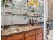 Bar area featuring glass shelving for glasses and bottles and a sink at 154 Hunters Hill Dr, Statesville, NC 28677