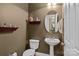 Charming powder room with pedestal sink and decorative shelving at 154 Hunters Hill Dr, Statesville, NC 28677